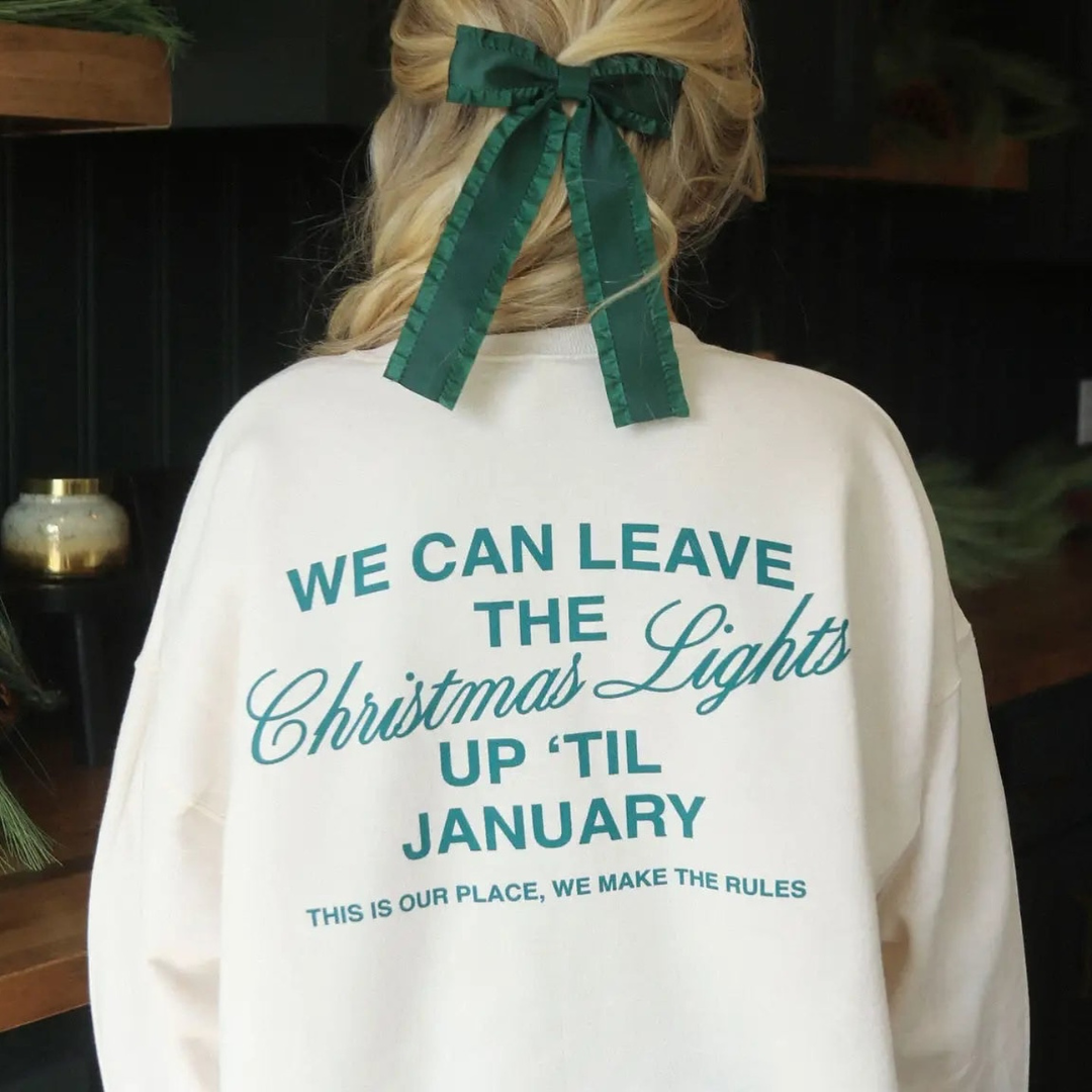The Golden Honey a girl wearing a sweatshirt that says "We Can Leave the Christmas Lights Up 'Til January This is our place and we make the rules.